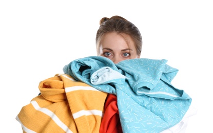 Photo of Young woman holding pile of dirty laundry on white background
