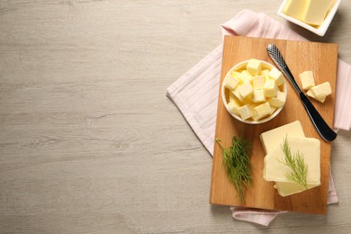 Tasty butter with dill and knife on wooden table, flat lay. Space for text