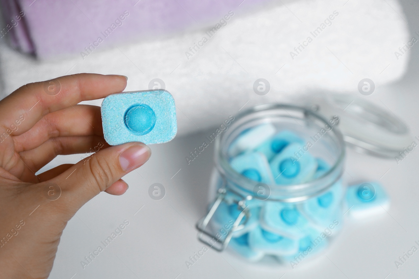 Photo of Woman holding water softener tablet, closeup view