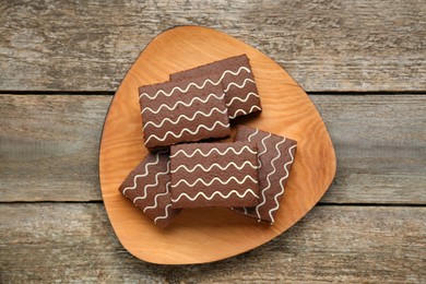 Tasty chocolate sponge cakes on wooden table, top view