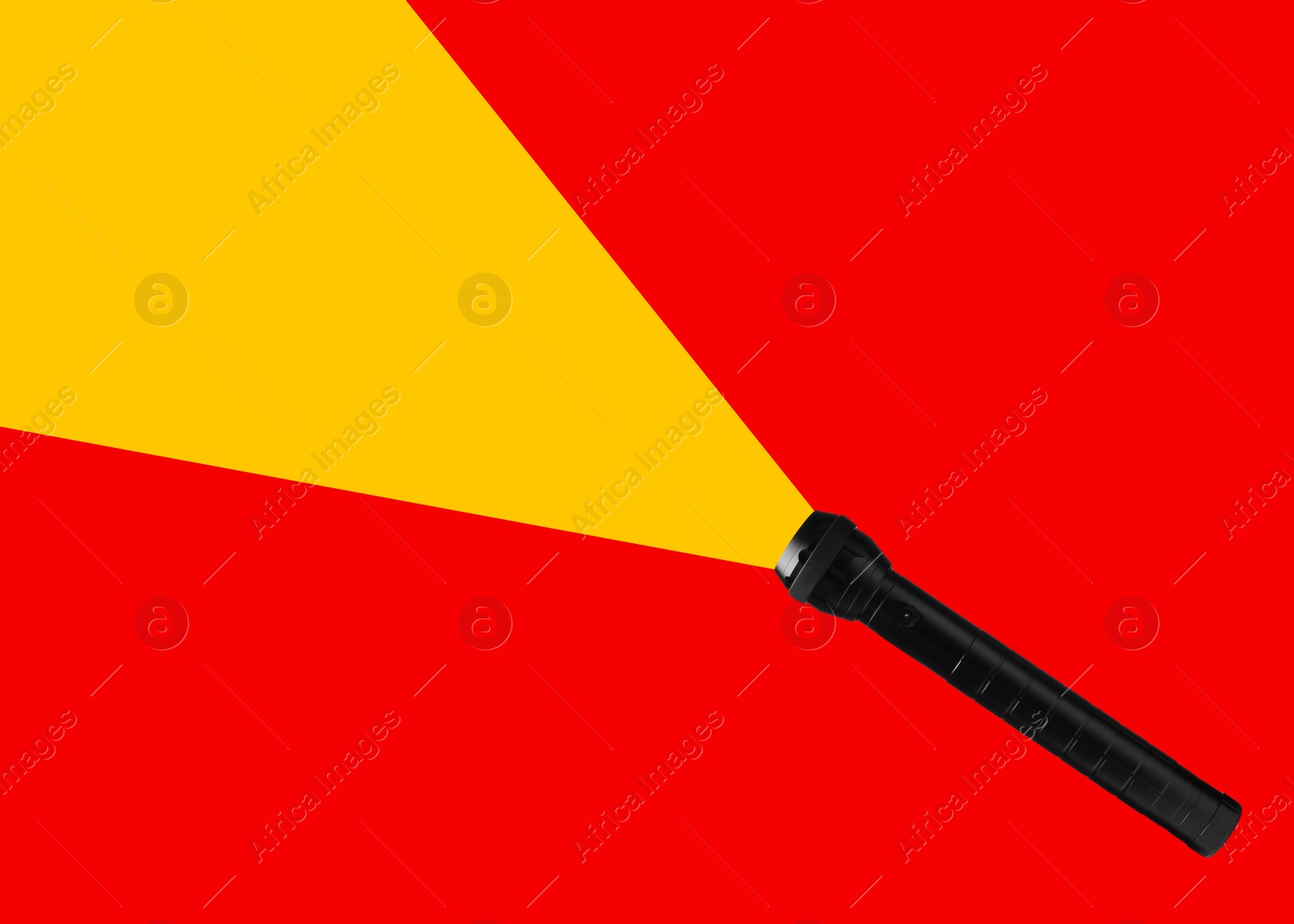 Image of Flashlight illuminating red background. Light symbolizing search, guidance, direction and other