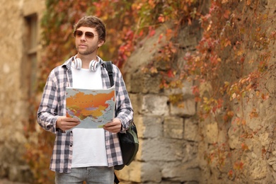 Photo of Traveler with world map near building outdoors