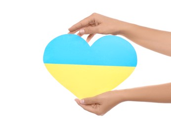 Photo of Woman holding paper heart in colors of Ukrainian flag on white background, closeup