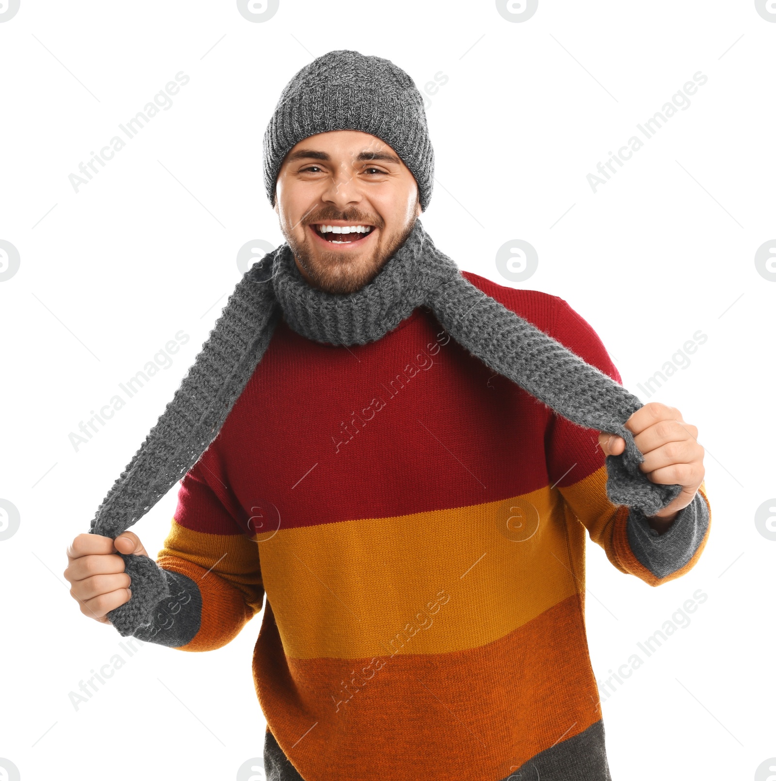 Photo of Emotional young man in warm clothes on white background. Winter vacation