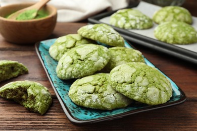 Photo of Tasty matcha cookies on wooden table, closeup