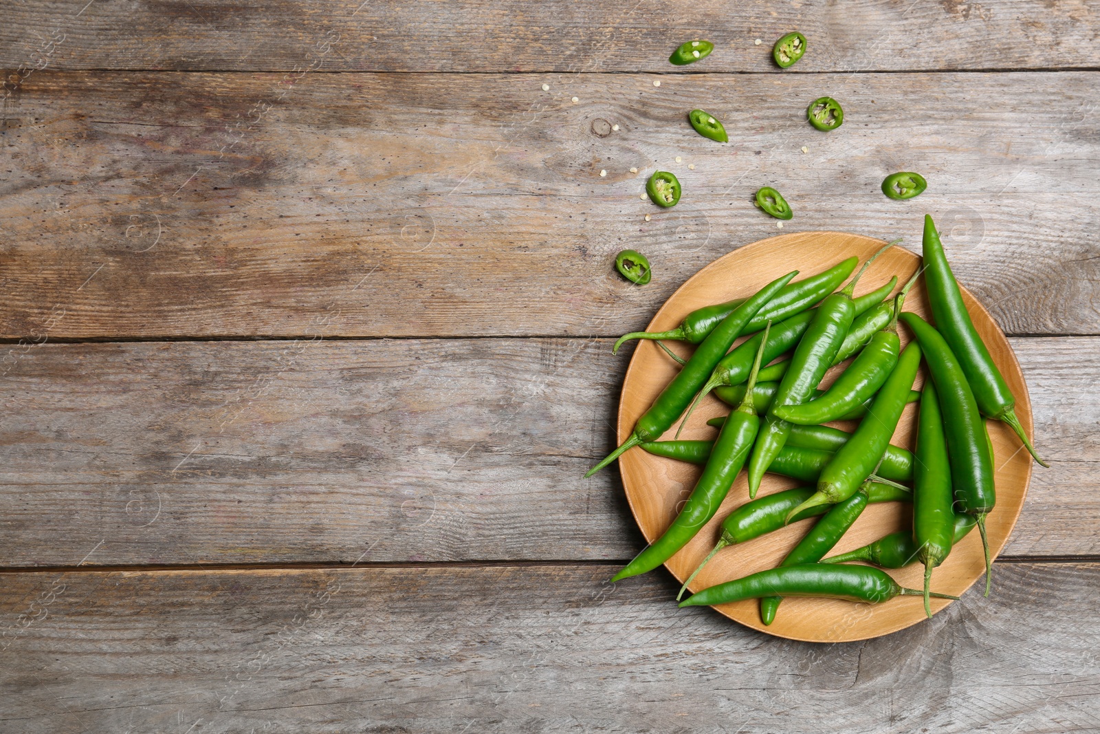 Photo of Flat lay composition with chili peppers on wooden background