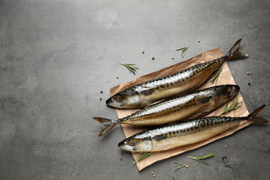 Photo of Tasty smoked fish on grey table, flat lay