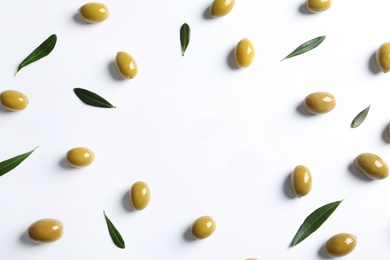 Flat lay composition with fresh olives covered with oil on white background