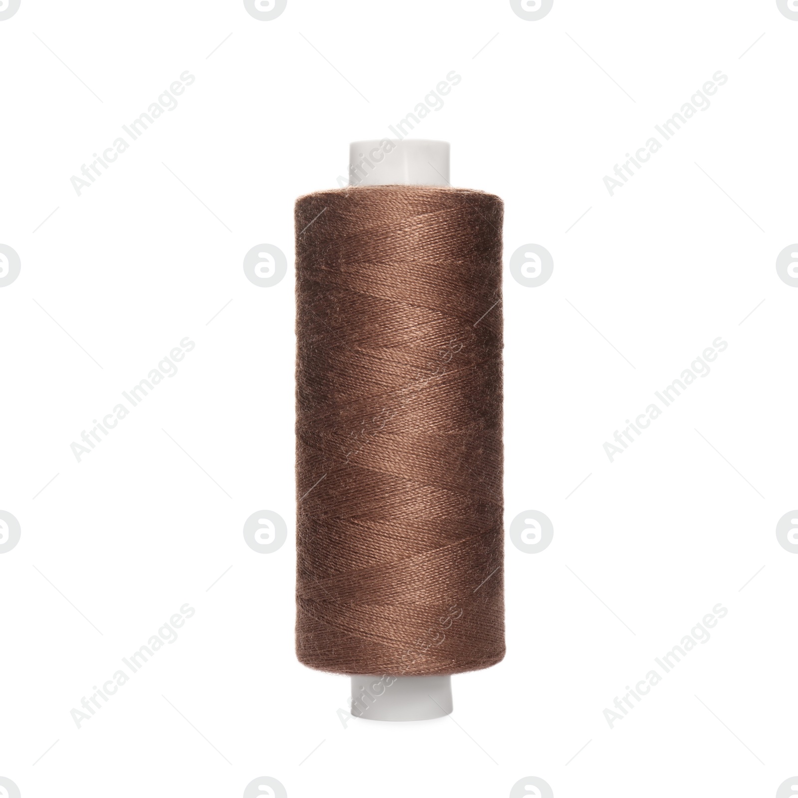 Photo of Spool of brown sewing thread isolated on white