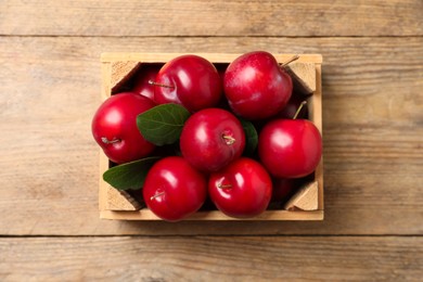 Photo of Fresh ripe cherry plums on wooden table, top view