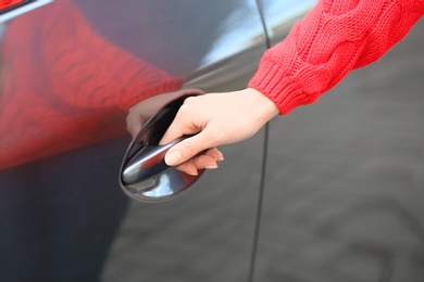 Closeup view of woman opening car door