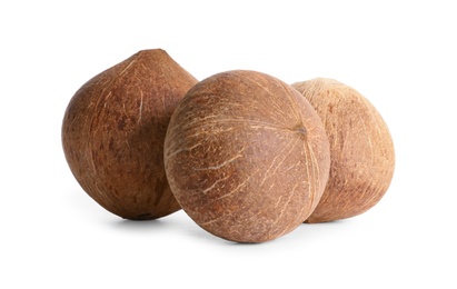 Ripe whole brown coconuts on white background