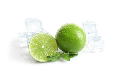 Fresh ripe limes and ice cubes on white background