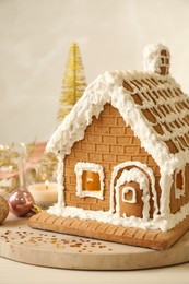 Beautiful gingerbread house decorated with icing on table