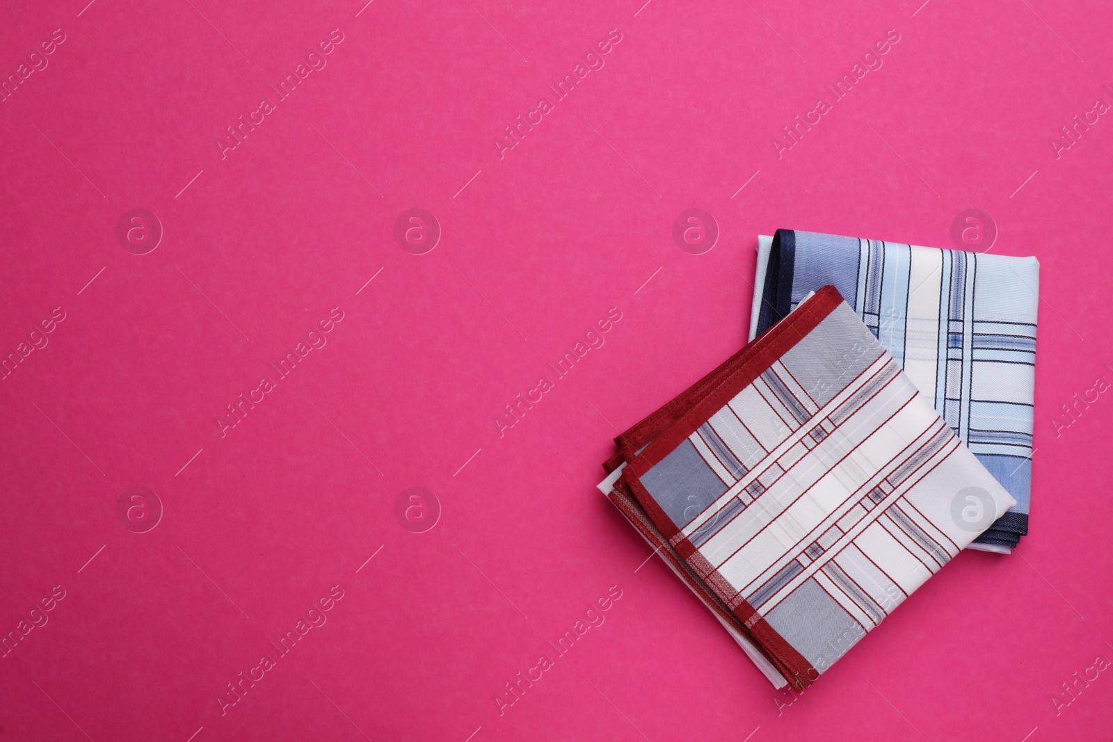 Photo of Stylish handkerchiefs on pink background, flat lay. Space for text