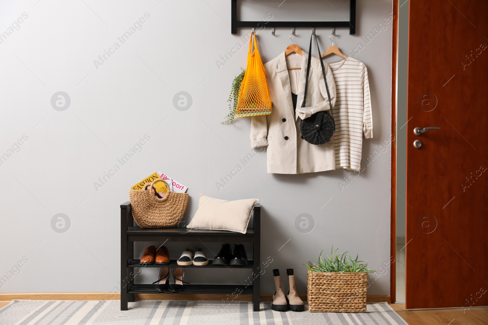 Photo of Hallway interior with stylish furniture, clothes and accessories