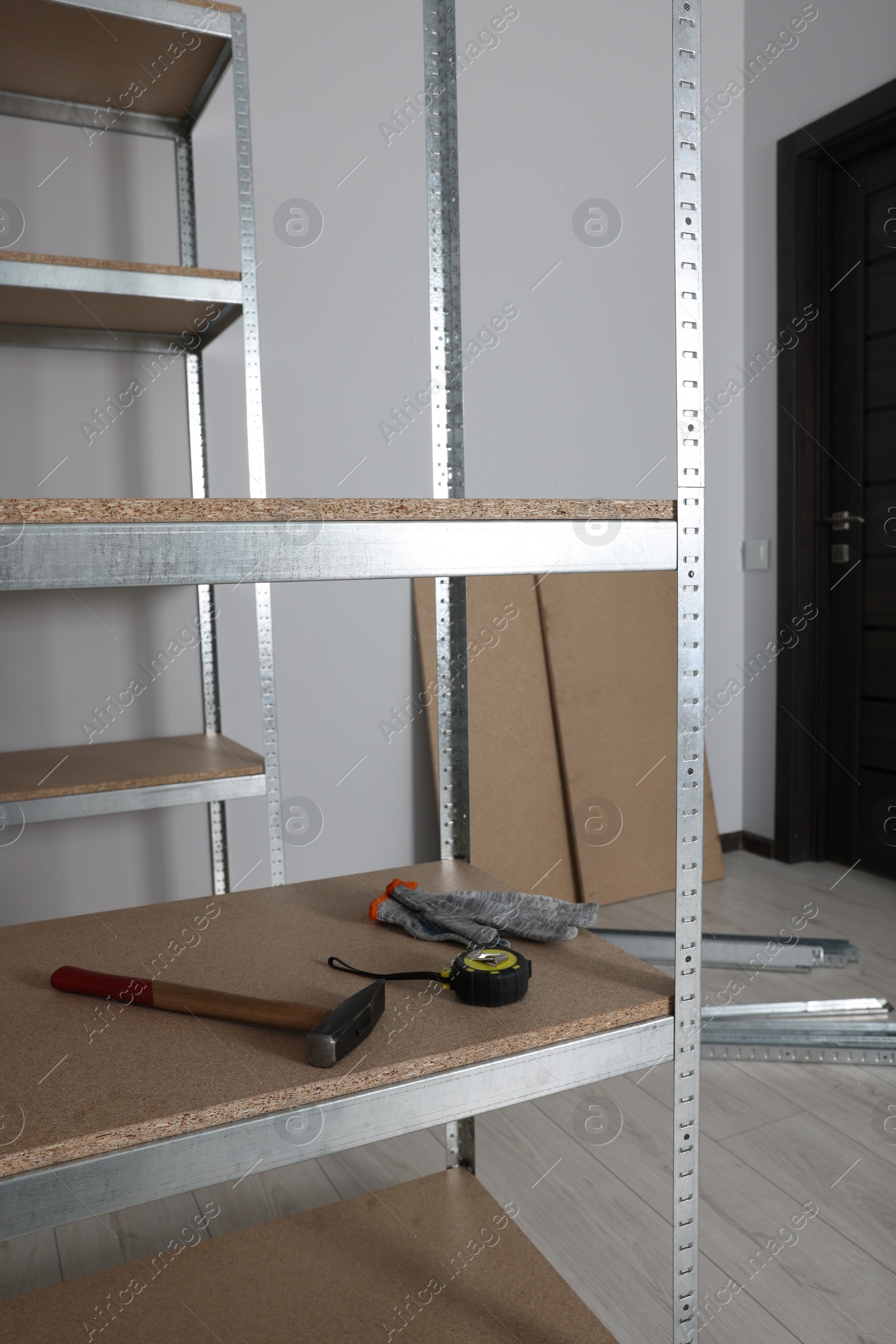 Photo of Metal storage shelf with room renovation tools in office