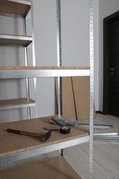 Photo of Metal storage shelf with room renovation tools in office