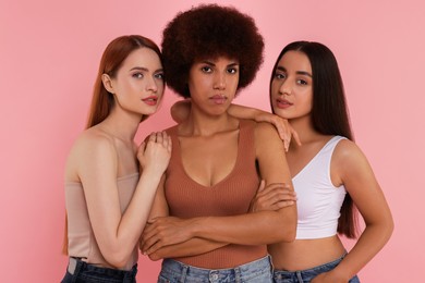Portrait of beautiful young women on pink background