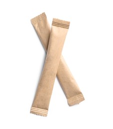 Photo of Beige sticks of sugar on white background, top view