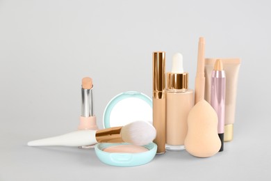 Photo of Foundation makeup products on light background. Decorative cosmetics