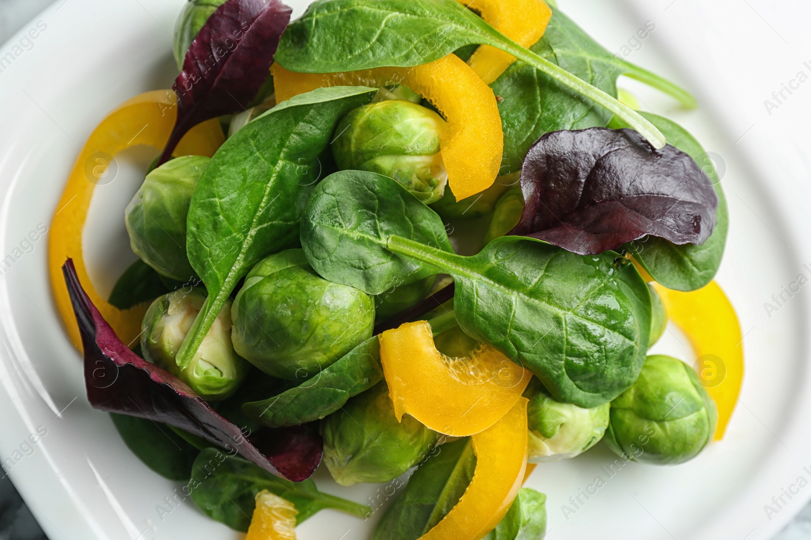 Photo of Tasty salad with Brussels sprouts on plate, top view