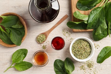 Photo of Flat lay composition with broadleaf plantain oil on white wooden table