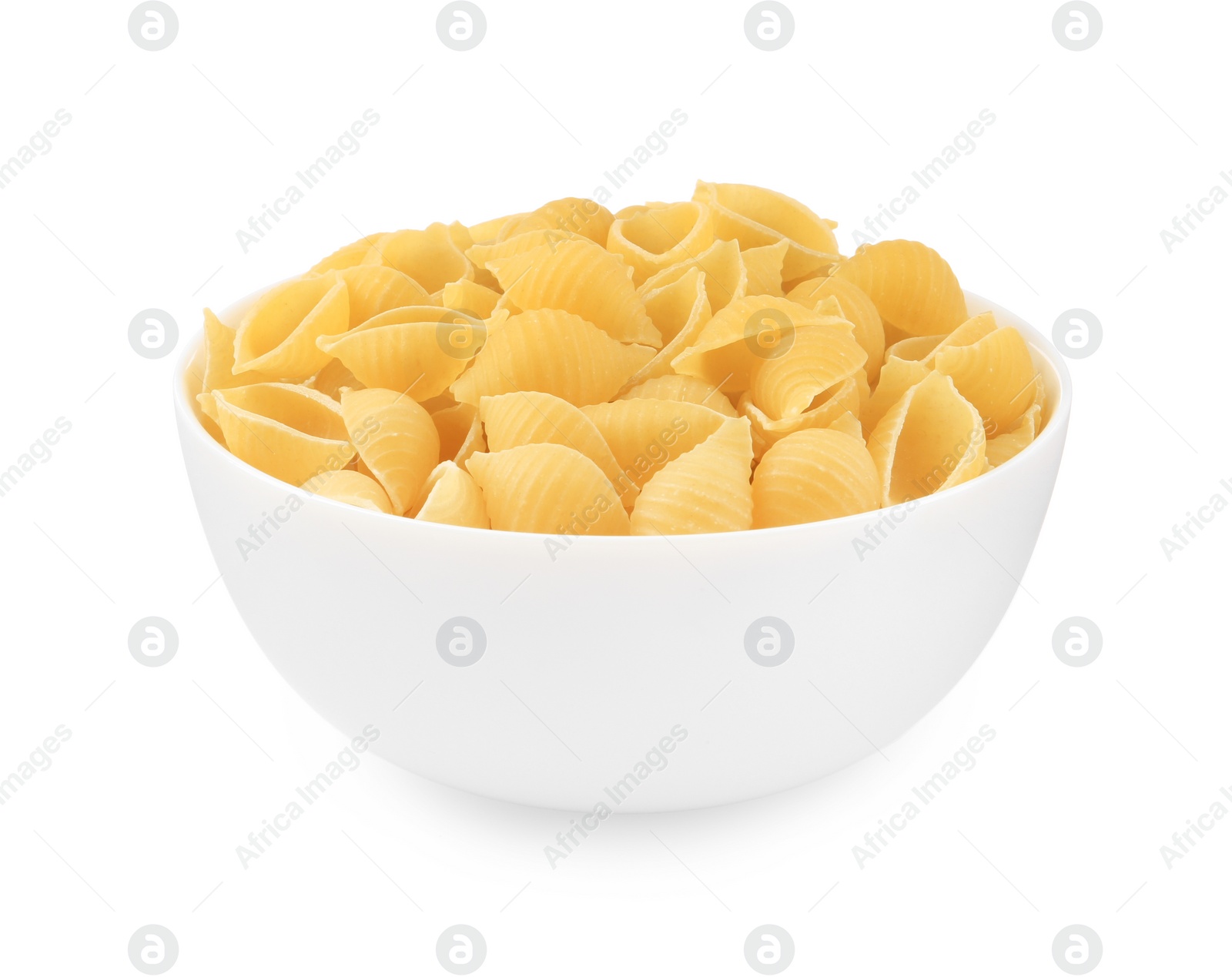 Photo of Raw conchiglie pasta in bowl isolated on white