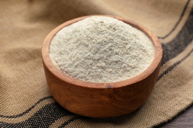 Quinoa flour in wooden bowl on table