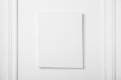 Photo of Blank canvas on white wall. Space for design