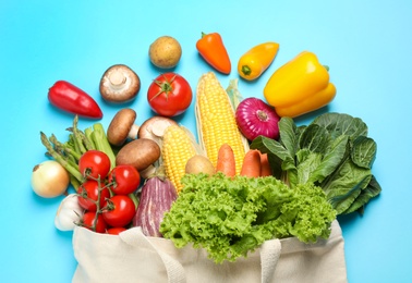 Photo of Different fresh vegetables on light blue background, flat lay