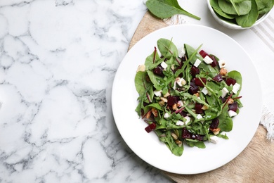 Delicious beet salad served on white marble table, flat lay. Space for text