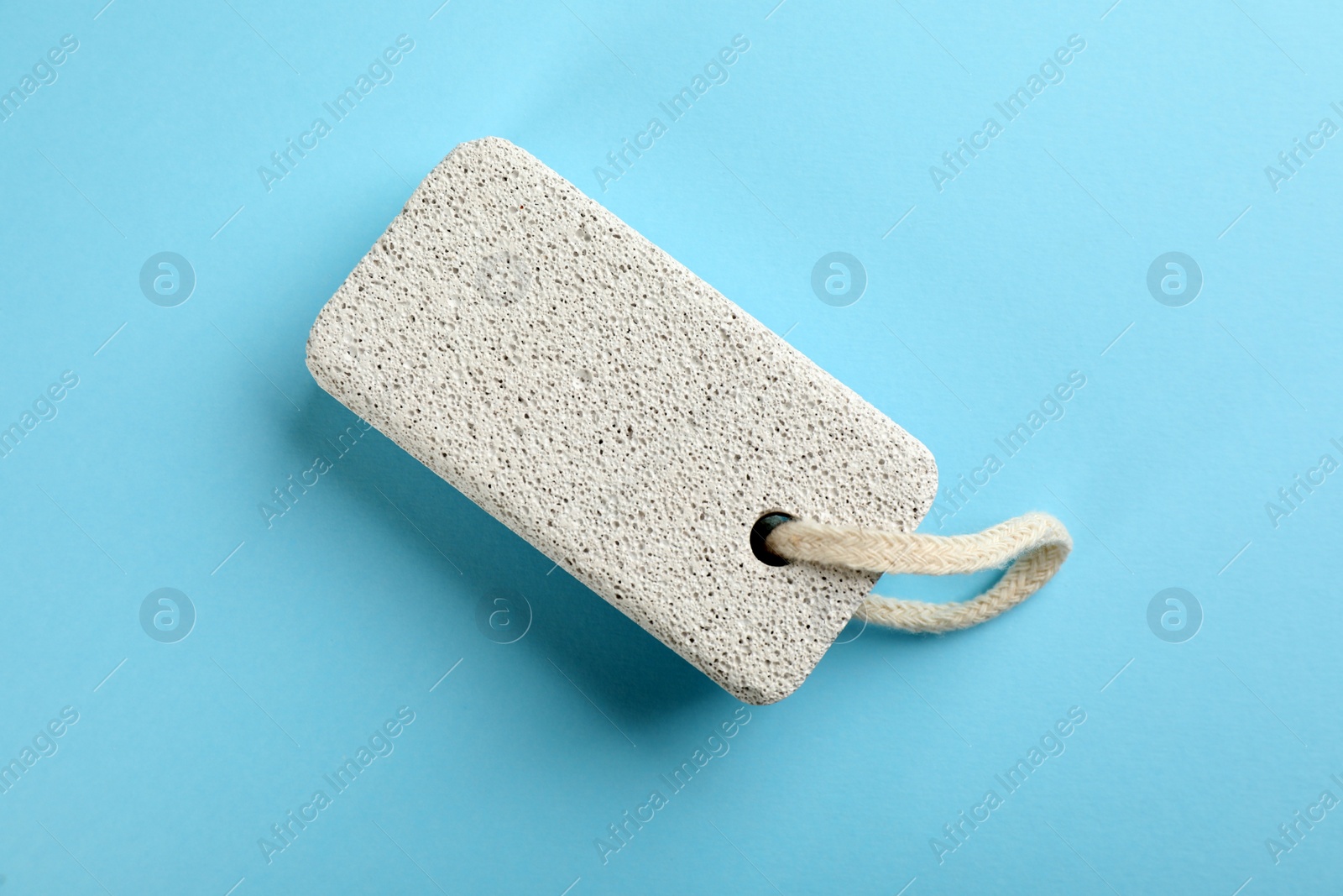 Photo of Pumice stone on light blue background, top view