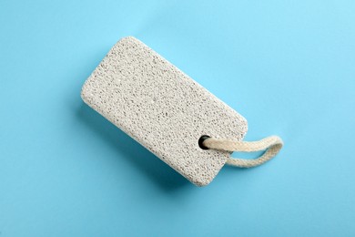 Pumice stone on light blue background, top view