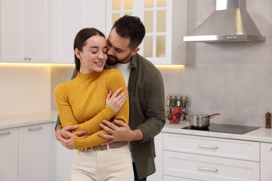 Lovely couple enjoying time together in kitchen