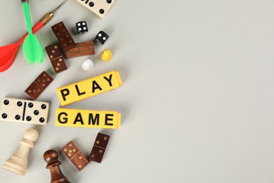 Photo of Flat lay composition of blocks with words Play Game on grey background. Space for text