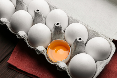 Photo of Fresh raw chicken eggs in box on table, closeup