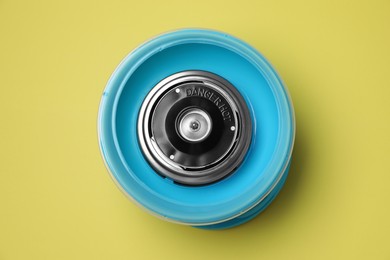 Photo of Portable candy cotton machine on yellow background, top view