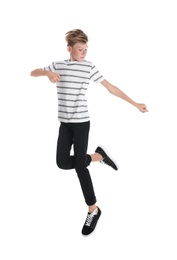 Portrait of young boy jumping on white background