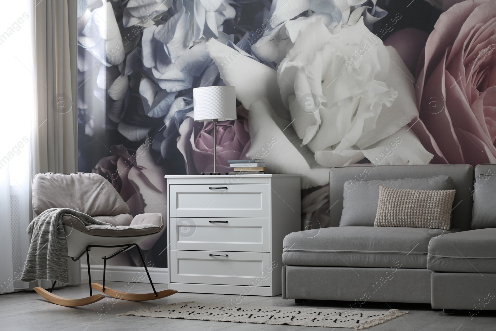 Photo of White chest of drawers in stylish living room. Interior design