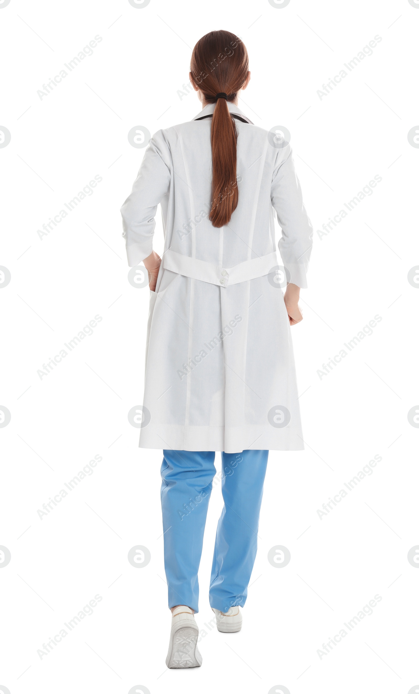 Photo of Doctor in clean uniform walking on white background