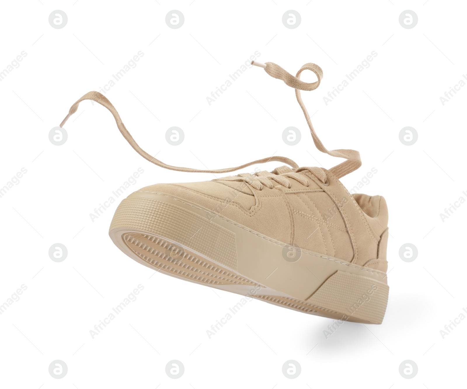 Photo of One stylish beige sneaker isolated on white