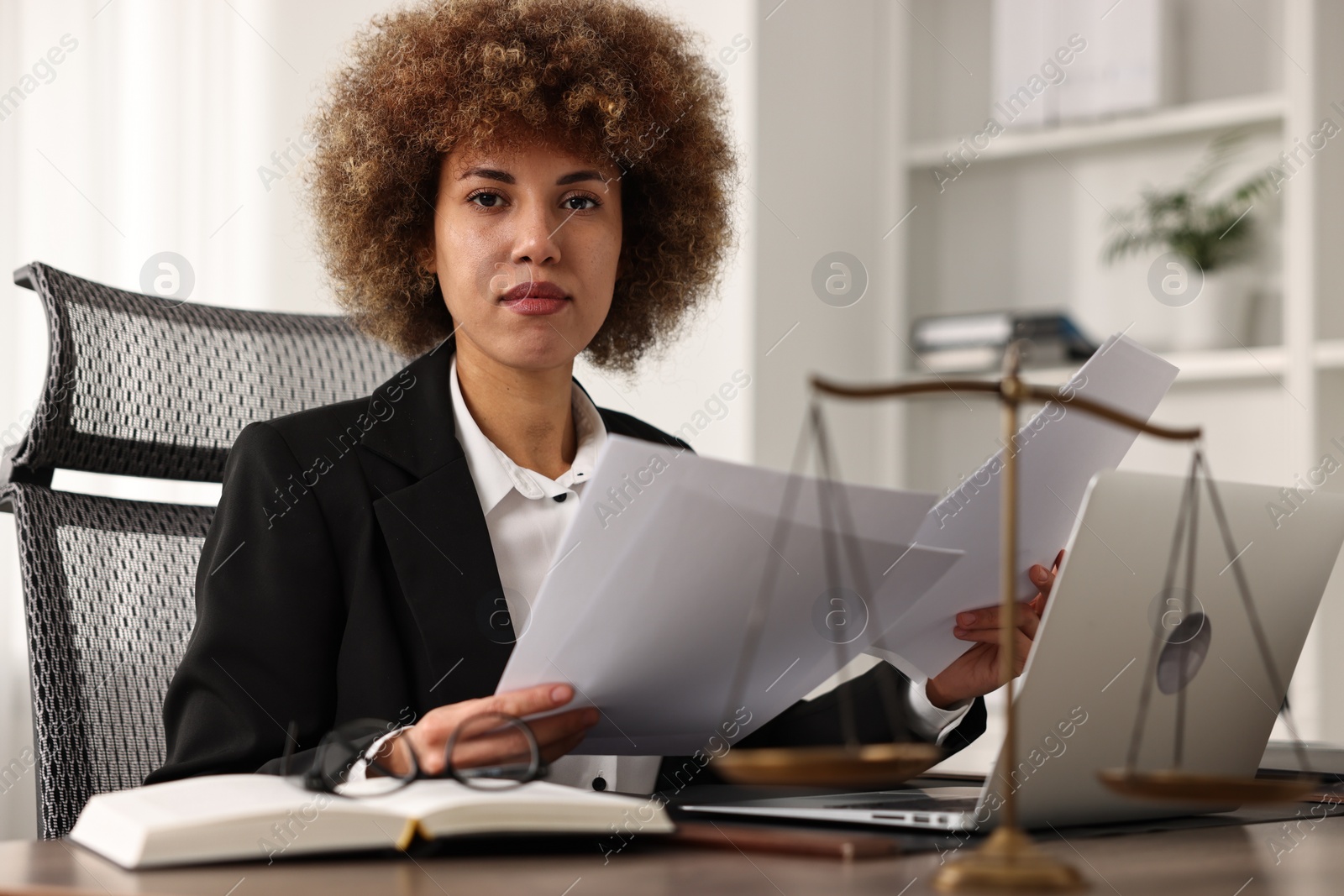 Photo of Notary working with documents at workplace in office