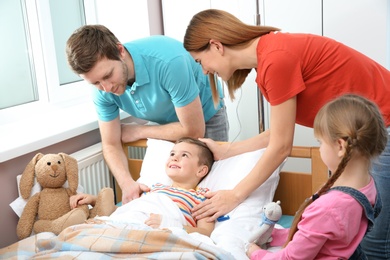 Photo of Happy family visiting little child in hospital