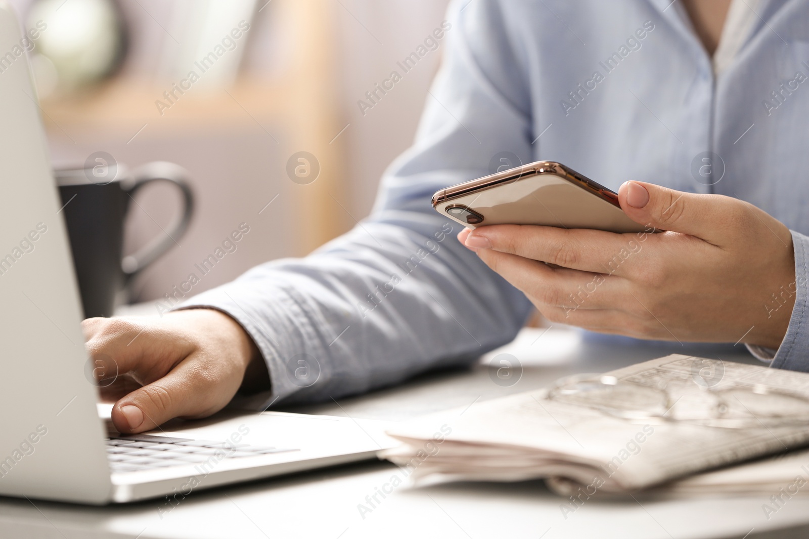 Photo of Journalist with smartphone working at table, closeup