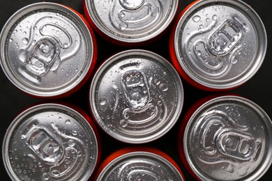 Photo of Energy drink in wet cans, top view. Functional beverage