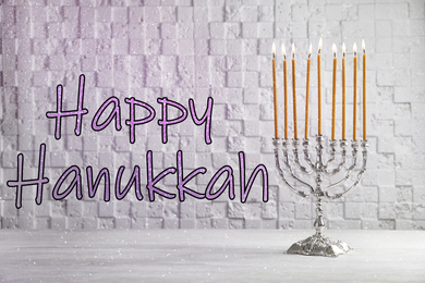 Image of Silver menorah on white wooden table. Happy Hanukkah!