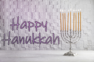 Silver menorah on white wooden table. Happy Hanukkah!