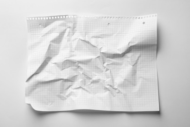 Crumpled sheet of paper on white background, top view