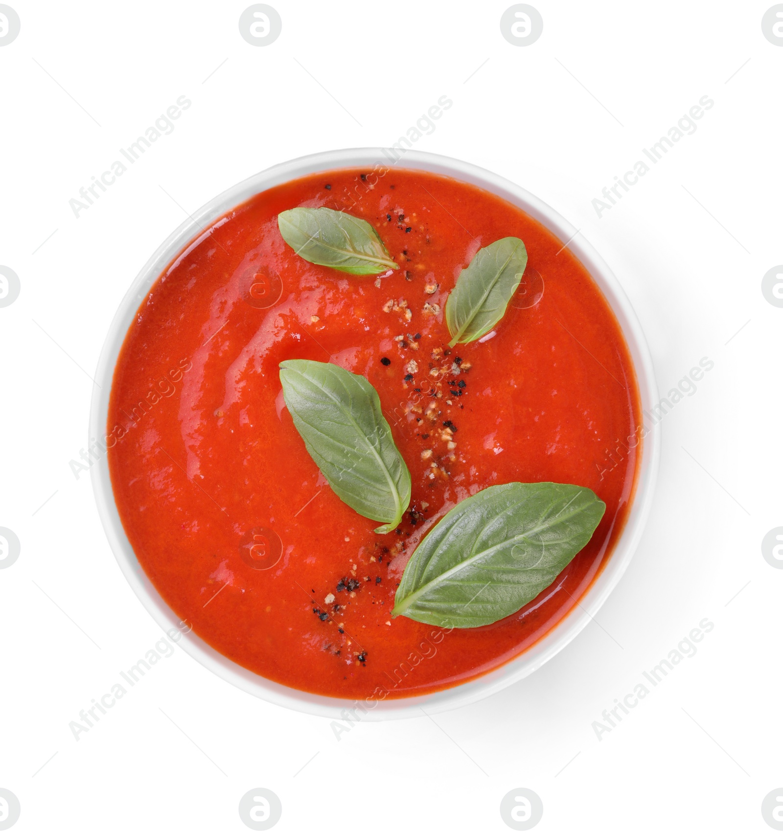 Photo of Delicious tomato soup with basil and spices isolated on white, top view